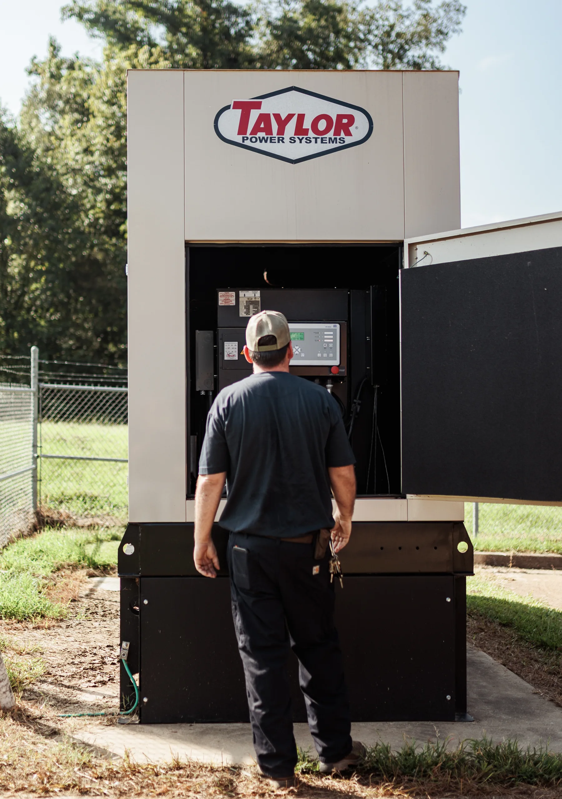 Emergency generator field service technician performing repairs